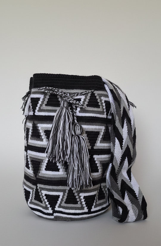 Detailed view of traditional Wayuu crochet technique and tassels on a mochila bag. Ethically and responsibly sourced.