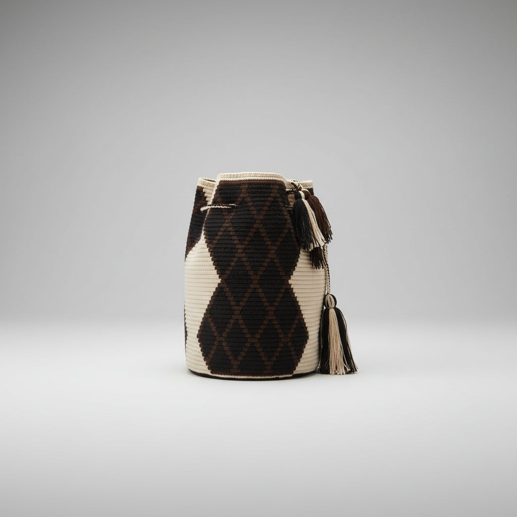 Reverse view of a handwoven bucket bag with a geometric pattern in cream and dark brown, displayed in studio setting.