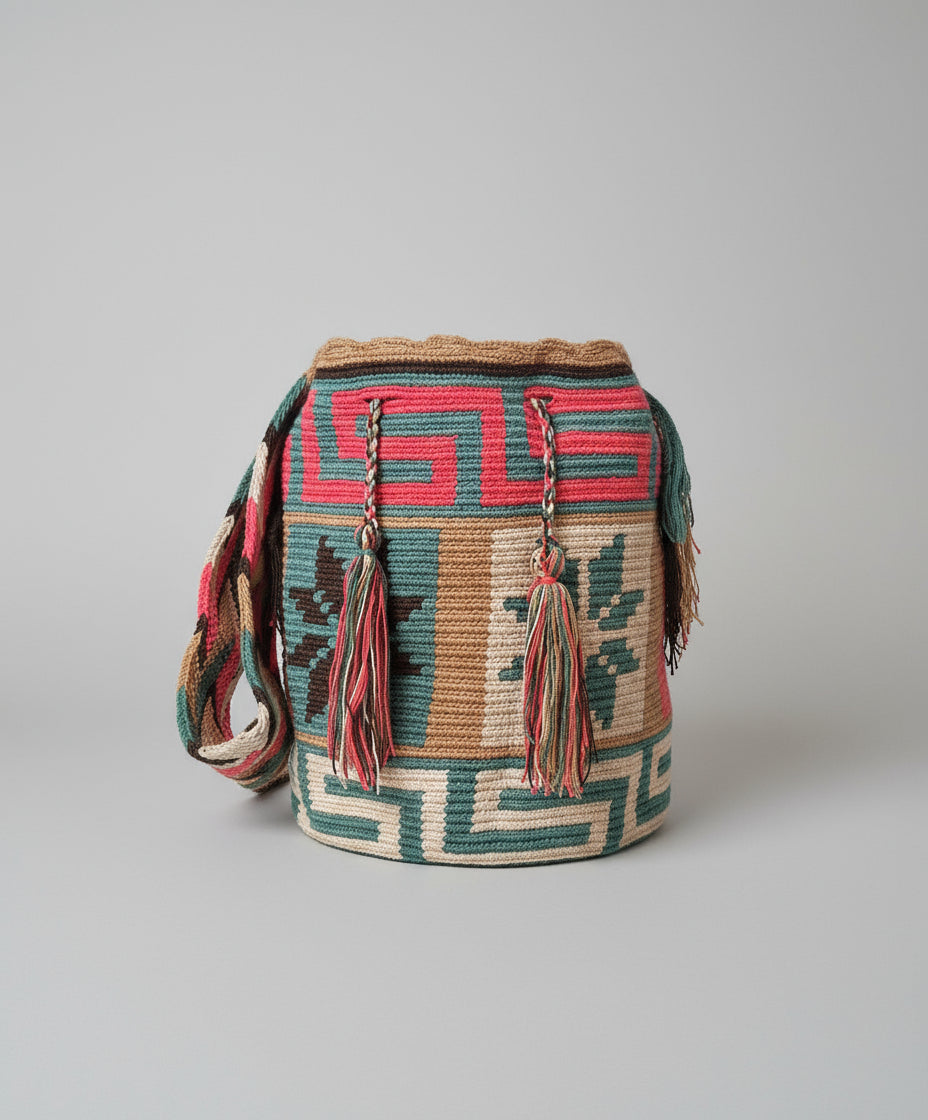 Authentic handmade Colombian Wayuu Mochila in vibrant cotton threads in turquoise, beige, green and pink with star design. Large Wayuu Bag is ethically sourced for a conscious boho wardrobe.
