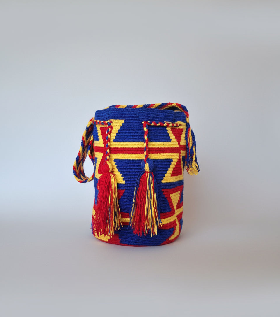 Authentic handmade Colombian Wayuu Mochila in vibrant cotton threads in  In Red, Yellow and Blue with geometric design. Large Wayuu Bag is ethically sourced for a conscious boho wardrobe.