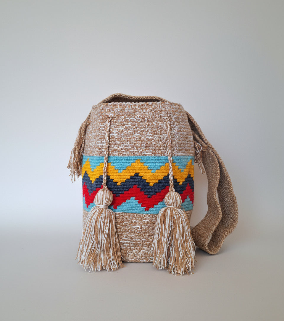 Large authentic handmade Colombian Wayuu Mochila in beige, yellow, red, navy and light blue cotton threads with zigzag design. Handwoven bag is ethically made, high-quality boho accessory.