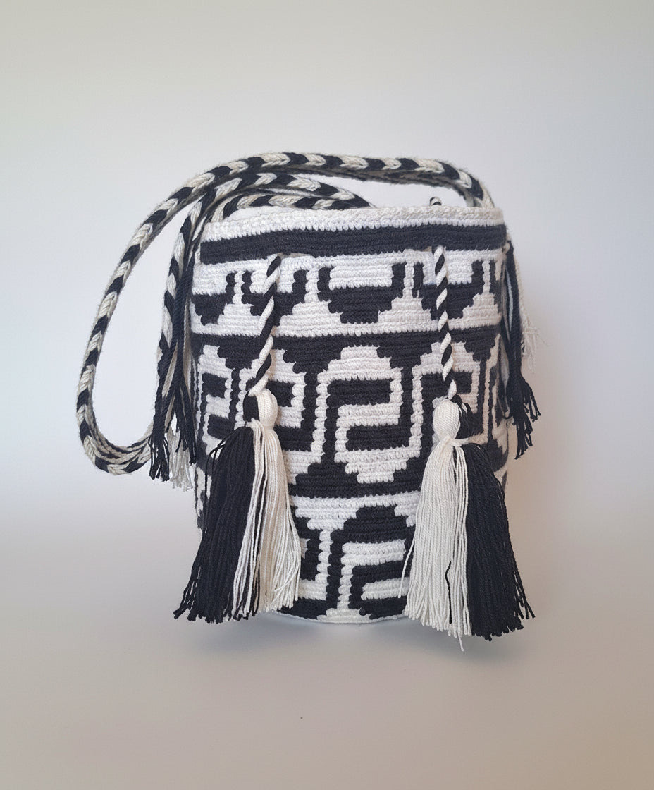 Authentic medium-sized handmade Colombian Wayuu Mochila with black and white serpentine pattern. Bag is sustainably sourced and styled for boho summer days.