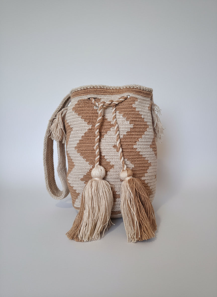 Authentic handmade Colombian Wayuu Mochila in beige and cream cotton threads, with zigzag design. Medium artisanal bag is ethically sourced for a conscious boho wardrobe.