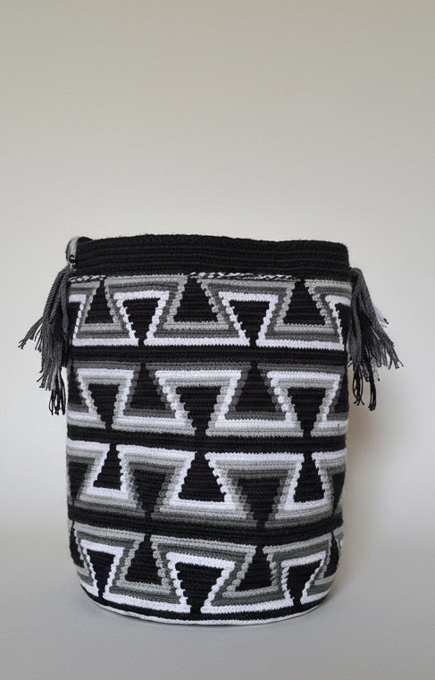 Detailed view of traditional Wayuu crochet technique and tassels on a mochila bag. Ethically and responsibly sourced.