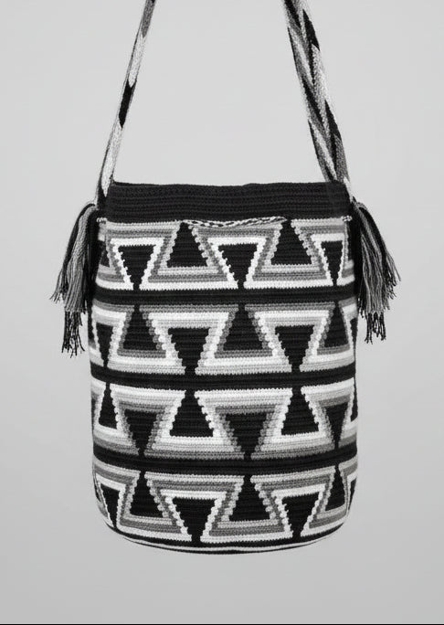 Detailed view of traditional Wayuu crochet technique and tassels on a mochila bag. Ethically and responsibly sourced.