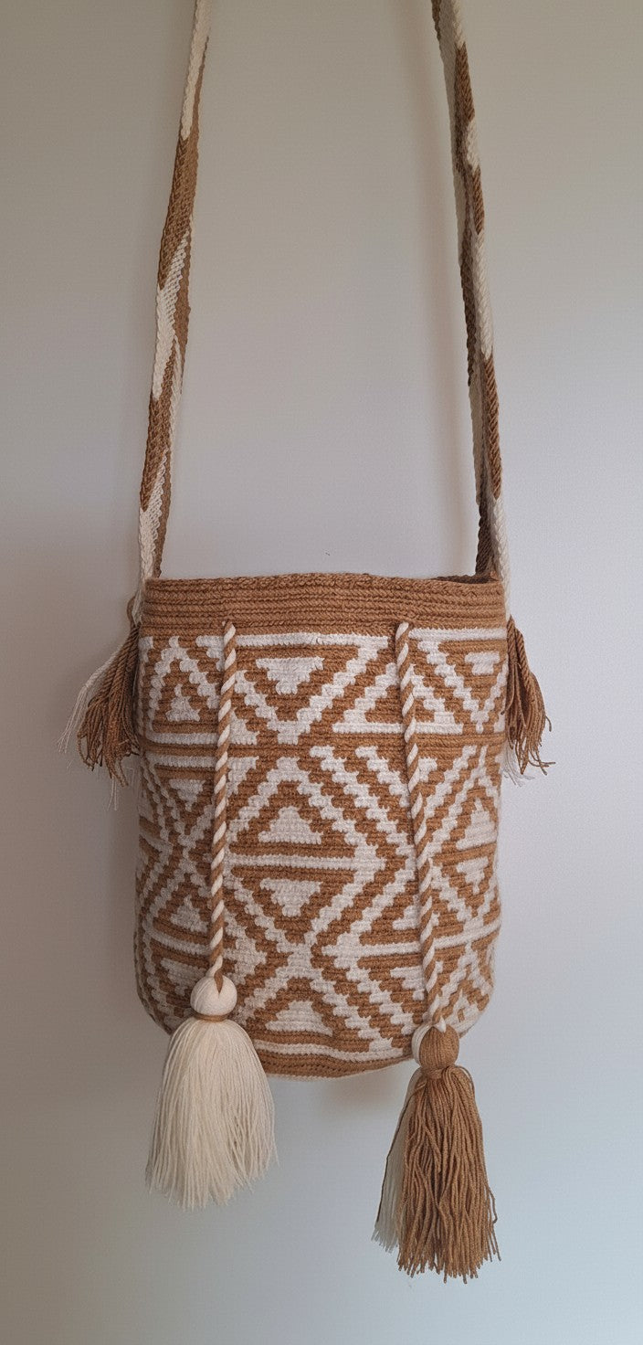 Detailed view of traditional Wayuu crochet technique and tassels on a mochila bag with crossbody strap extended. Ethically and responsibly sourced.