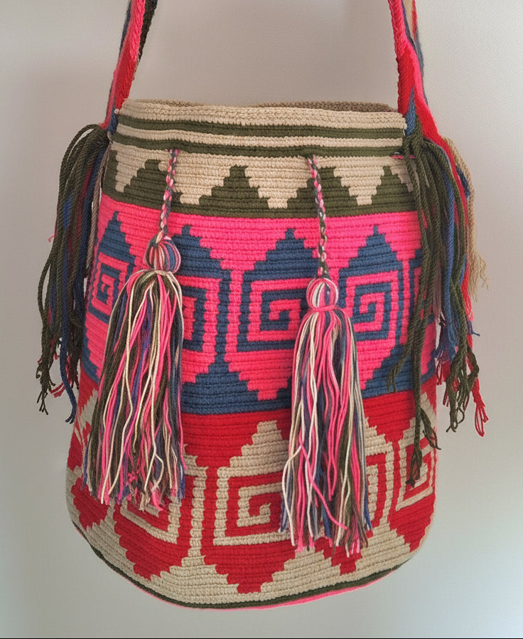 Detailed view of traditional Wayuu crochet technique and tassels on large mochila. Fair trade bucket bag is perfect for a free-spirited look.