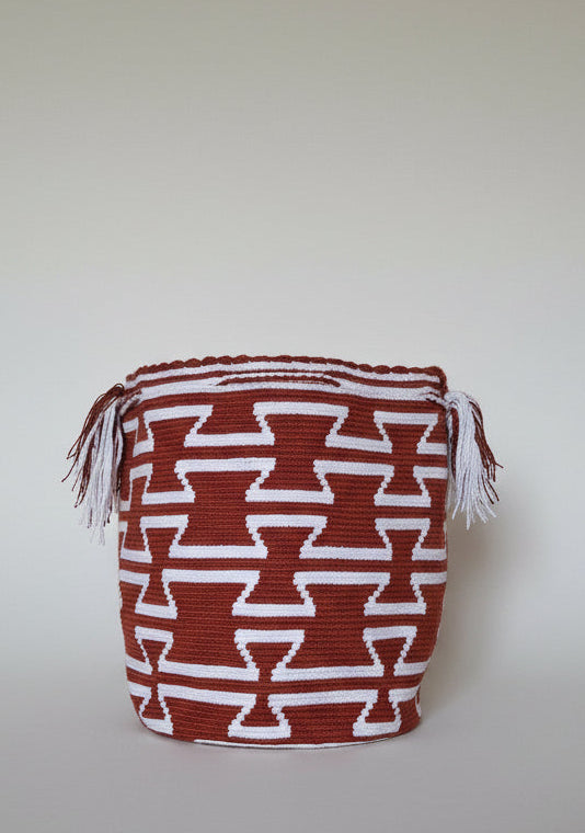 Detailed view of traditional Wayuu crochet technique and tassels on a mochila bag in red and white rear view. Ethically and responsibly sourced.