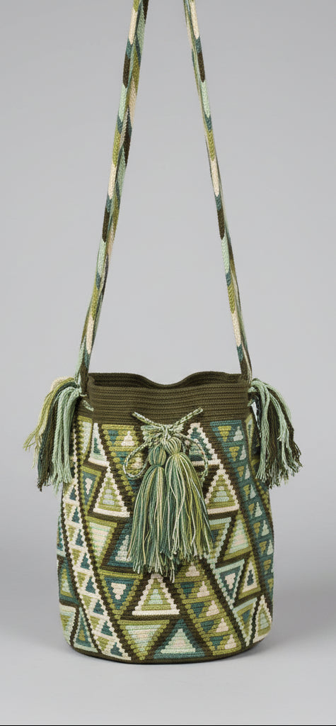 Detailed view of traditional Wayuu crochet technique and tassels on a green and white mochila bag with crossbody strap fully extended. Ethically and responsibly sourced.