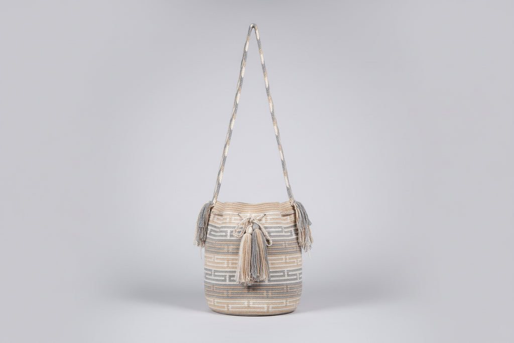 Detailed view of traditional Wayuu crochet technique and tassels on a mochila bag with crossbody strap fully extended. Ethically and responsibly sourced.
