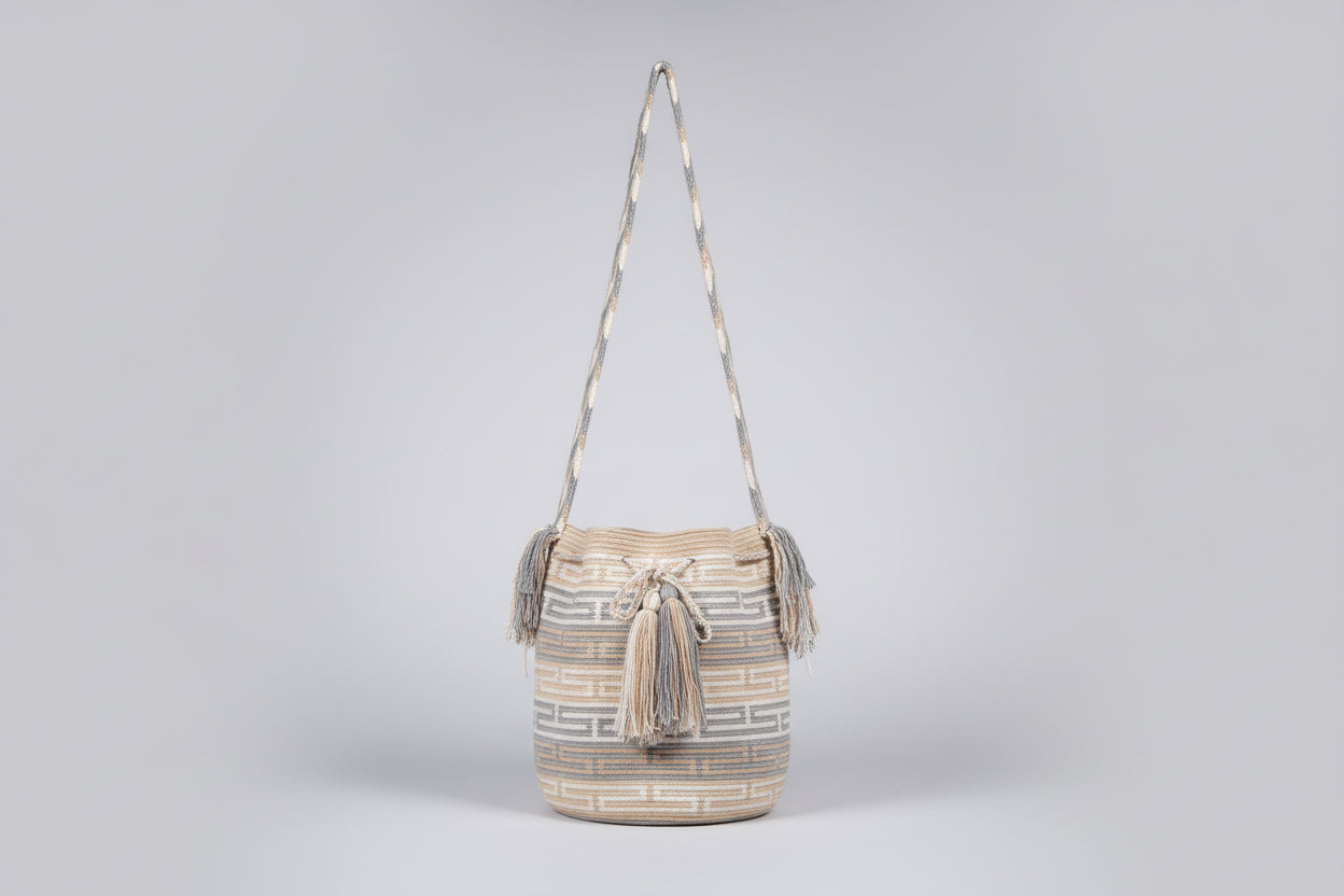 Detailed view of traditional Wayuu crochet technique and tassels on a mochila bag with crossbody strap fully extended. Ethically and responsibly sourced.