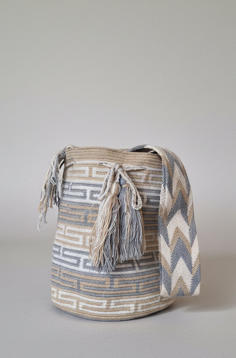 Authentic handmade Colombian Wayuu Mochila in vibrant cotton threads, geometric design in soft colours Ethically and responsibly sourced.