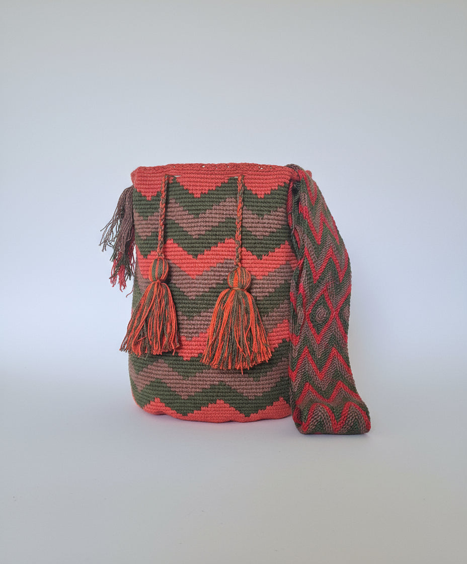 Authentic handmade Colombian Wayuu Mochila in green, red and tan cotton threads with zigzag design. Large artisanal bag is fair trade bucket bag for a free-spirited look.