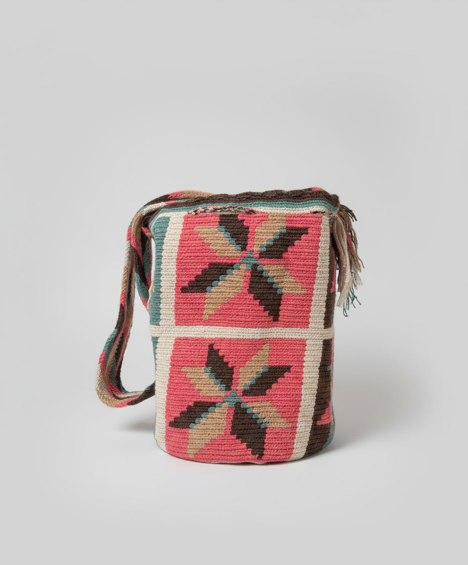 Authentic handmade Colombian Wayuu Mochila in pink, brown and turquoise cotton threads with flower design. Large bag is artisan-made and perfect for boho styling.