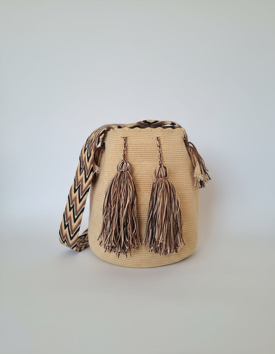 Authentic handmade Colombian Wayuu Mochila in light-mustard cotton thread. Bag is ethically made, high-quality boho accessory.