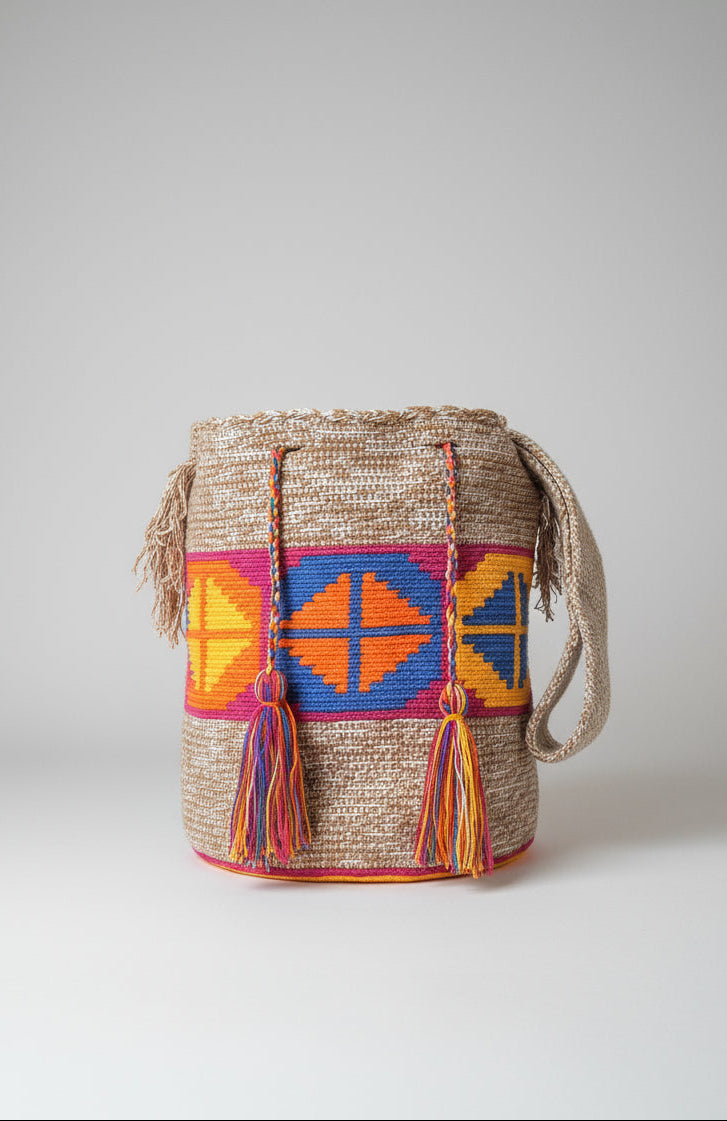Authentic handmade Colombian Wayuu Mochila in vibrant cotton threads, with rhombus design in marbled beige, pink, blue, orange and yellow. Bag is ethically sourced for a conscious boho wardrobe.
