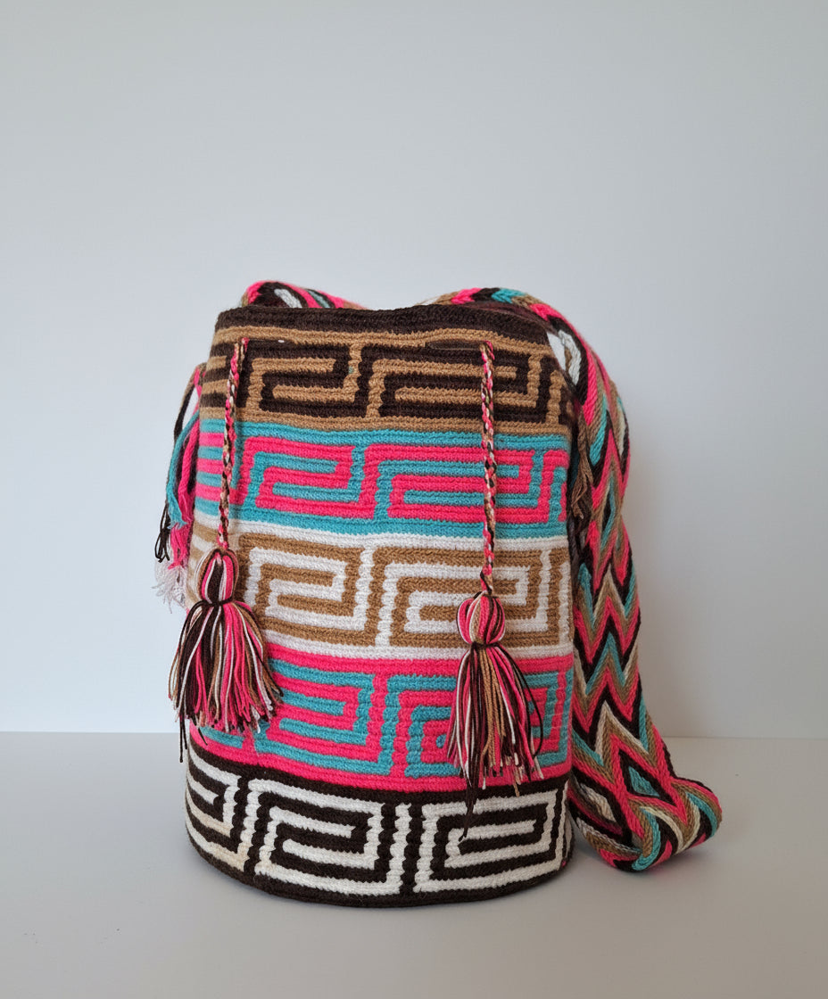 Authentic handmade Colombian Wayuu Mochila in vibrant cotton threads, with labyrinth designs. Large bag is sustainably sourced and styled for boho summer days.