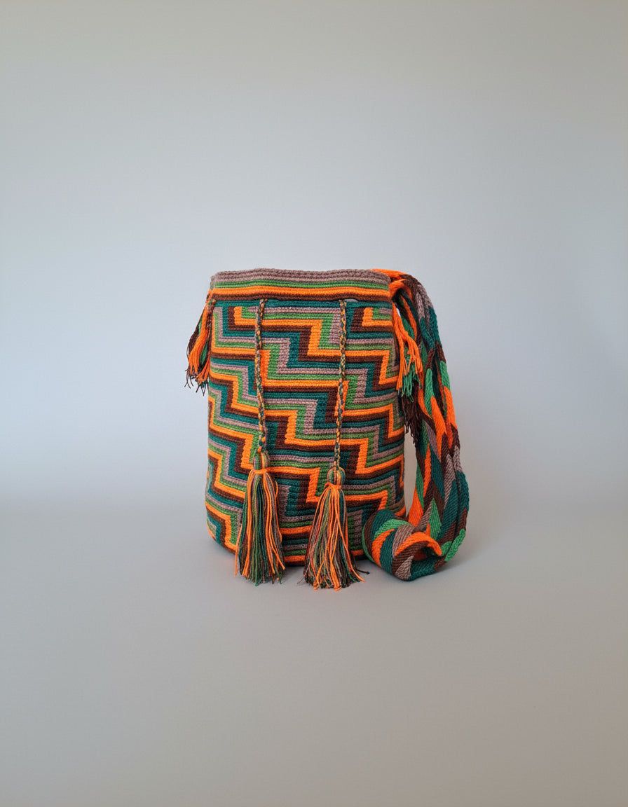 Authentic handmade Colombian Wayuu Mochila in vibrant orange, brown, grey and green cotton threads with zigzag design. Large wayuu bag is unique and supports indigenous weavers with every boho purchase.