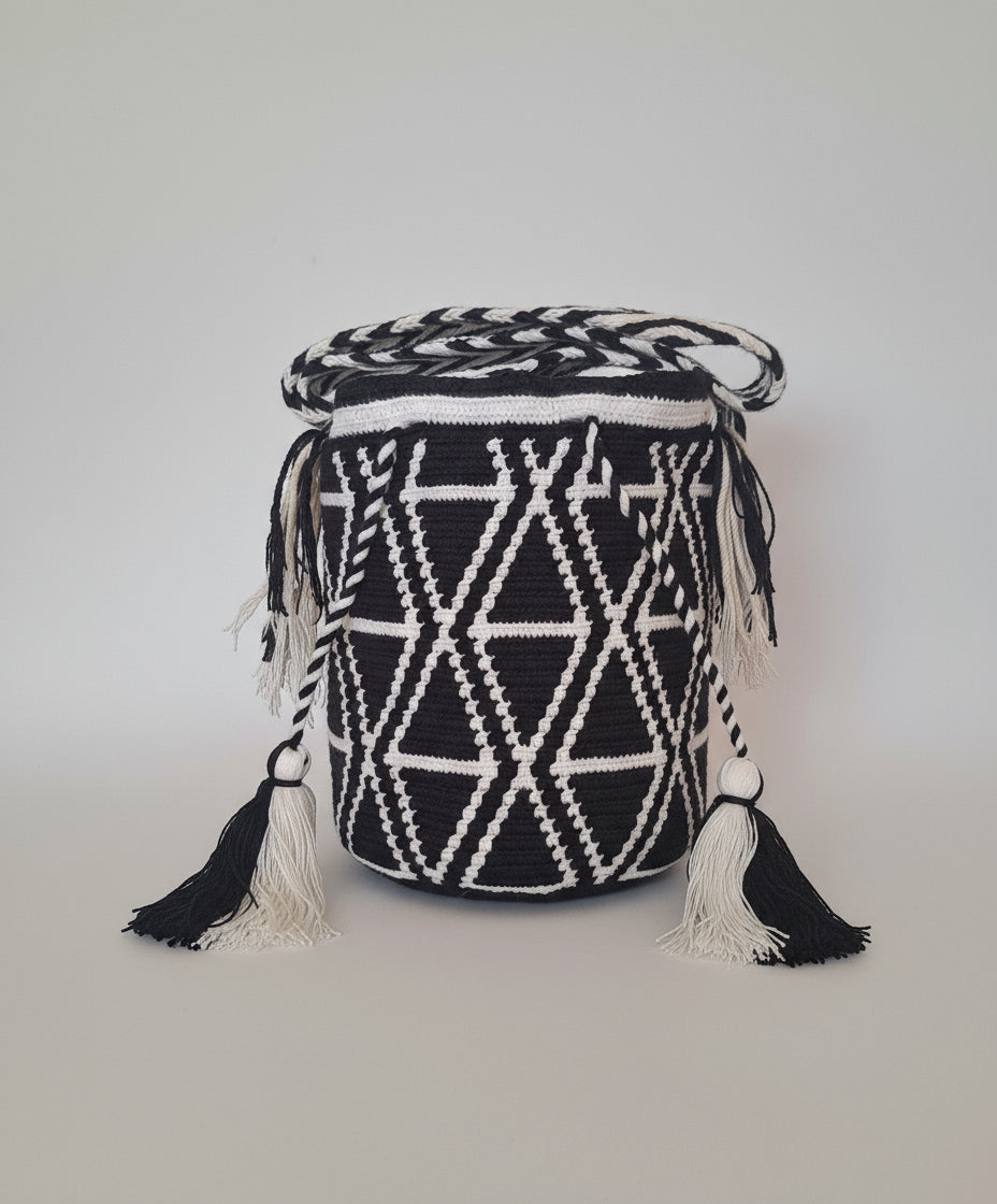 Authentic handmade Colombian Wayuu Mochila, medium, in triangle design and back and white. Bag is traditionally crafted and adds a tribal touch to boho fits.