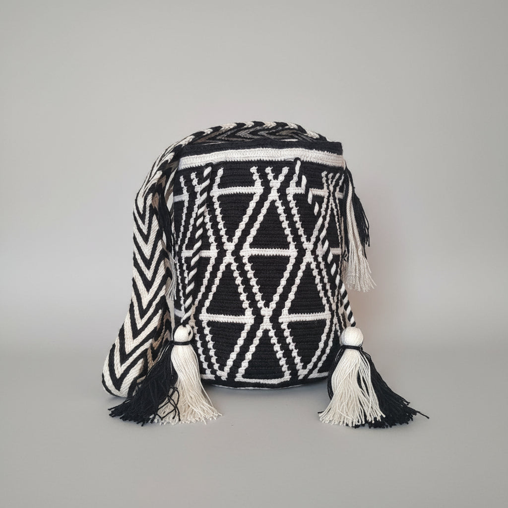 Authentic handmade Colombian Wayuu Mochila, medium, with triangle design in back and white with tassels. Bag is artisan-made and perfect for boho styling