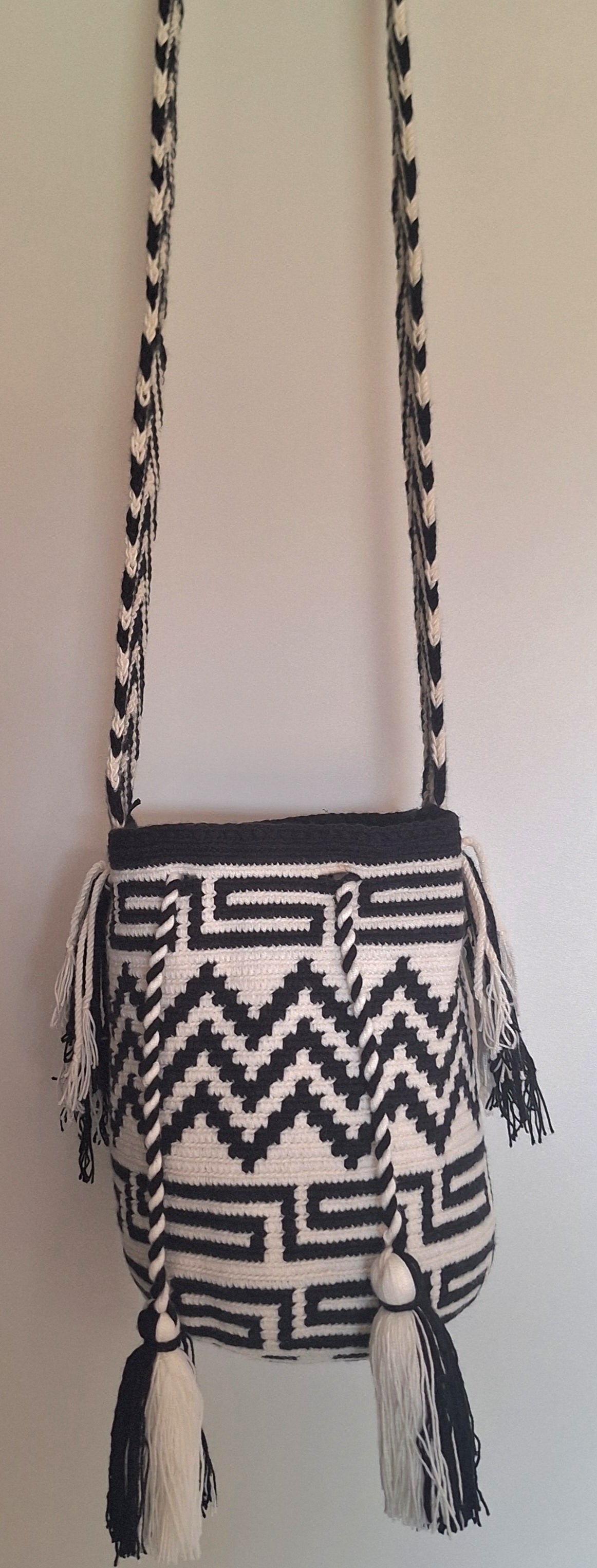 Detailed view of medium Wayuu Bag Zigzag and Labyrinth Design in Black and White with crossbody strap fully extended. Mochila is fair trade bucket bag for a free-spirited look.