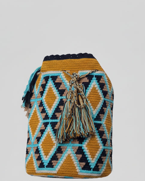 Detailed view of traditional Wayuu crochet technique and tassels on a mochila bag in turtle shell design. Ethically and responsibly sourced.