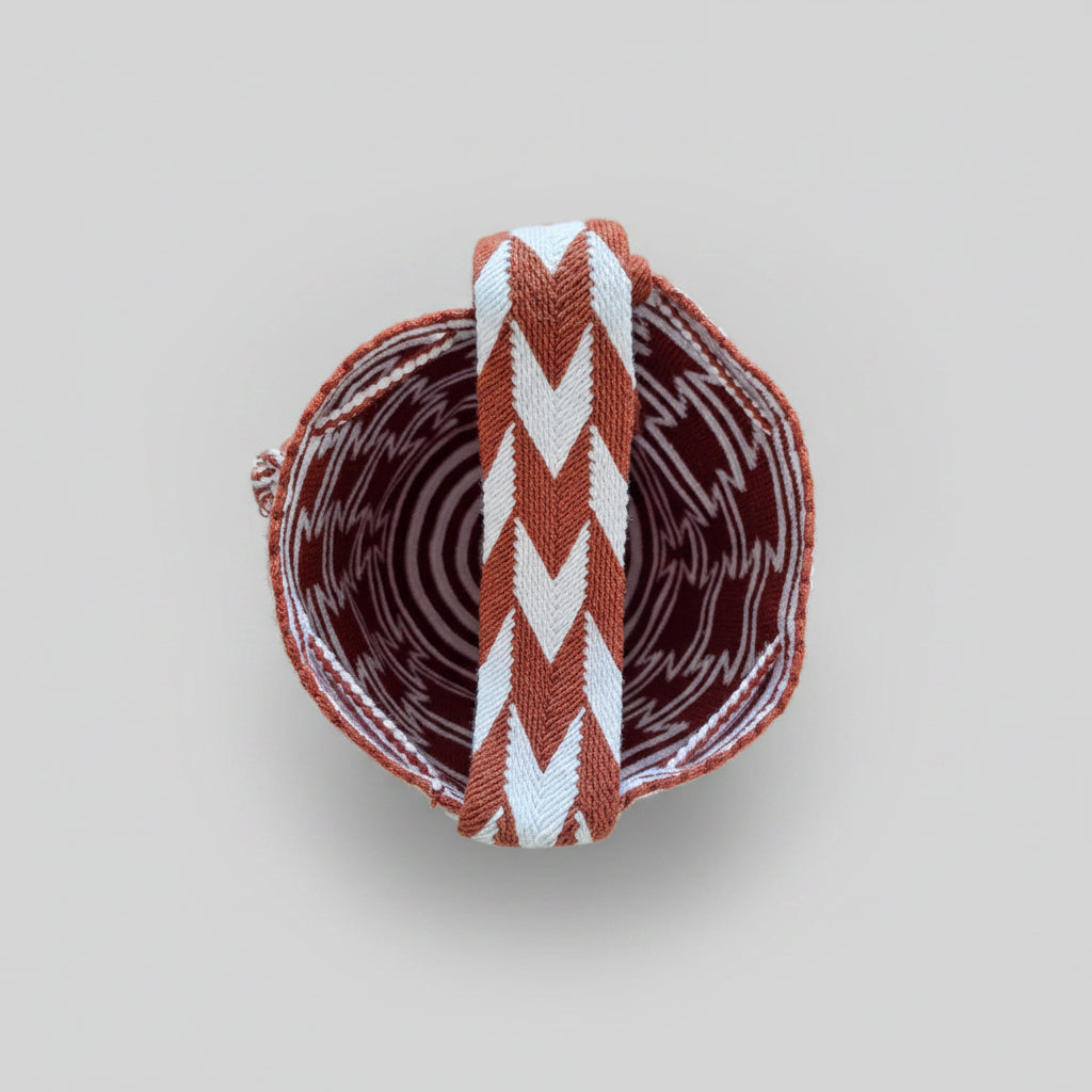 Over view of red and white Wayuu mochila bag, with detail of interior. Handwoven crochet design is perfect for ethical shoppers.