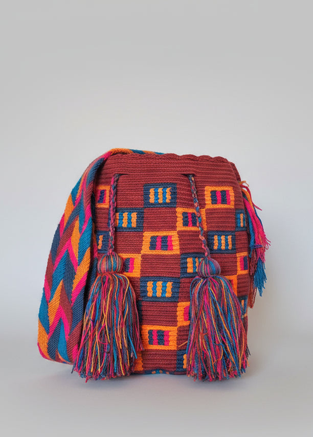 Authentic handmade Colombian Wayuu Mochila in rich red, orange and blue cotton threads, geometric design. Ethically and responsibly sourced.