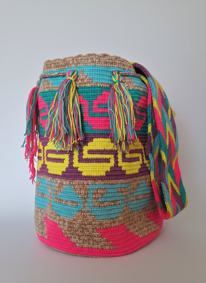 Authentic handmade Colombian Wayuu Mochila in beige pink and yellow cotton threads with serpentine design. Bag is traditionally crafted; adds a tribal touch to boho fits.