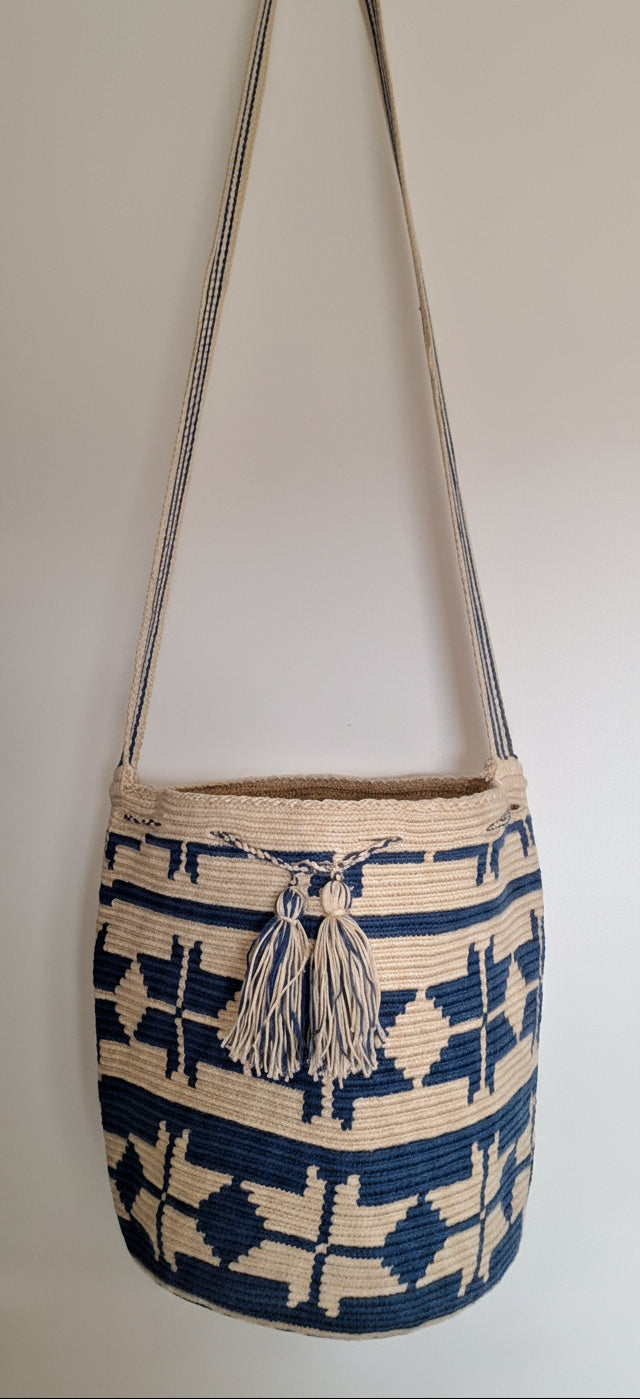 Detailed view of traditional Wayuu beach bag with tassels on a mochila bag with crossbody strap fully extended. Ethically and responsibly sourced.