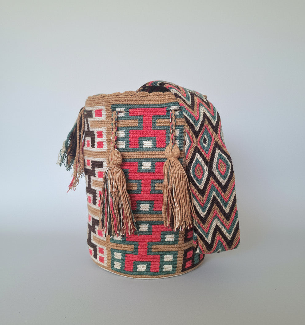 Authentic handmade Colombian Wayuu Mochila in oink, beige and blue cotton threads, geometric design. Ethically and responsibly sourced.