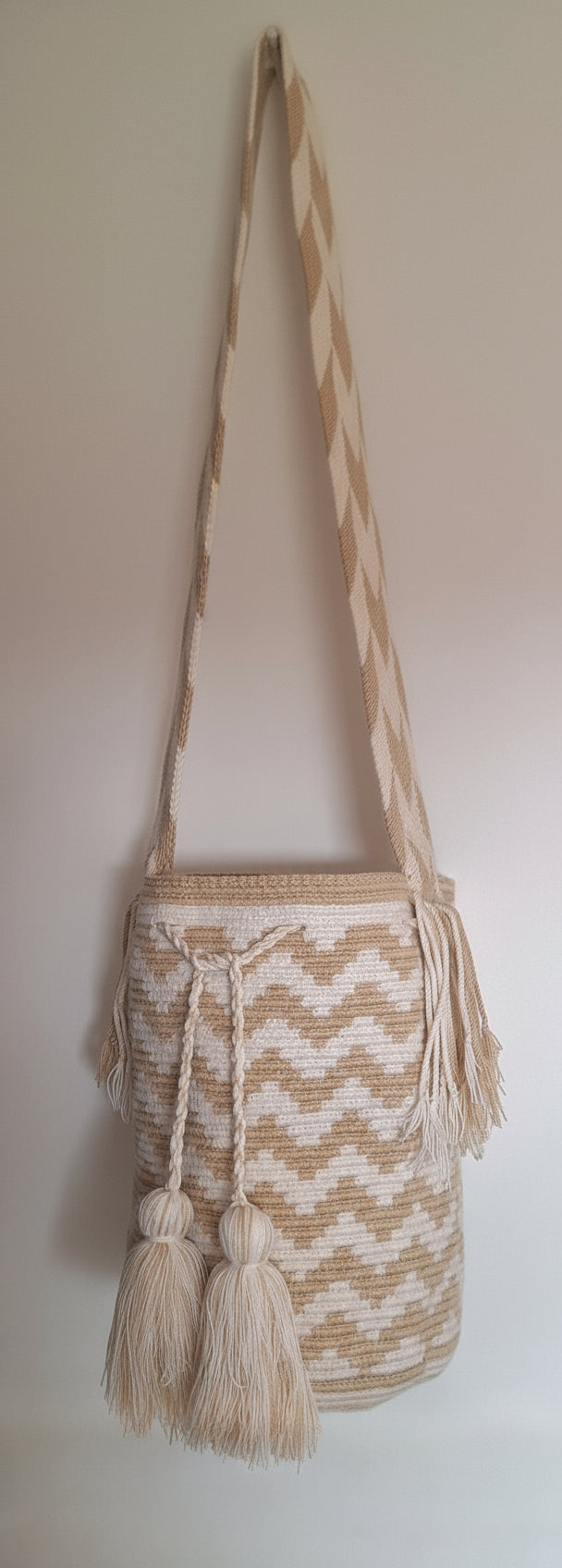 Detailed view of traditional Wayuu zigzag design and tassels on a mochila bag with crossbody strap fully extended. Ethically and responsibly sourced.